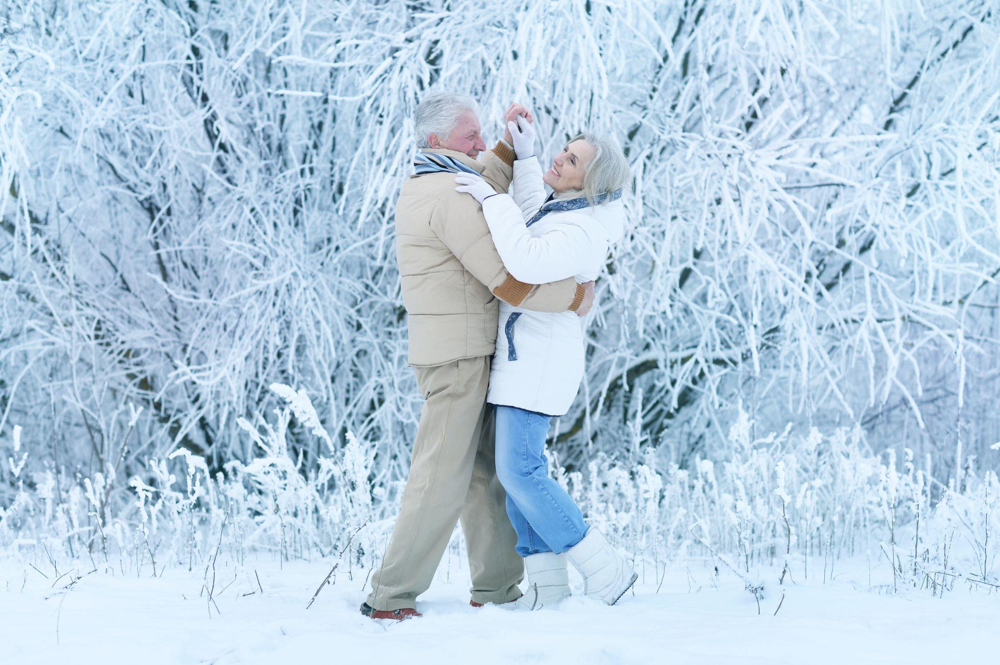 Senior couple dancing romantically in the snow